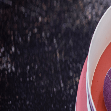 Black background with part of a pink cake(right).